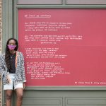The poet Asiya Wadud stands by one of her pieces from “Echo Exhibit” (2020) in New York City’s Seaport district, co-presented by the Lower Manhattan Cultural Council (LMCC), the Seaport district and the Howard Hughes Corporation as part of River To River 2020: Four Voices.
