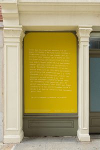 A large vinyl poem installation. The poem reads: "every day at a time / but fractured / as my ankle ice skating / waiting / until the bone is completely healed / i had to move into my sister's house / change has a purpose we can see / how nature replenishes itself / without our input / birds appreciate / in their natural habitat and don't dwell in city noises / i could pinpoint / red cardinals / the red chested robin / let me tell you / the squirrel who looks in our window every day / is very concerned / she is pregnant but / lacks the knowledge of our history / of our african-american community / being from the Caribbean / i can share this with my nieces and nephews / that people are coming together / in one voice / standing-up for a belief / as bad as covid is / they can connect / with love".