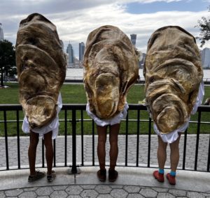 Three people wearing oyster costumes